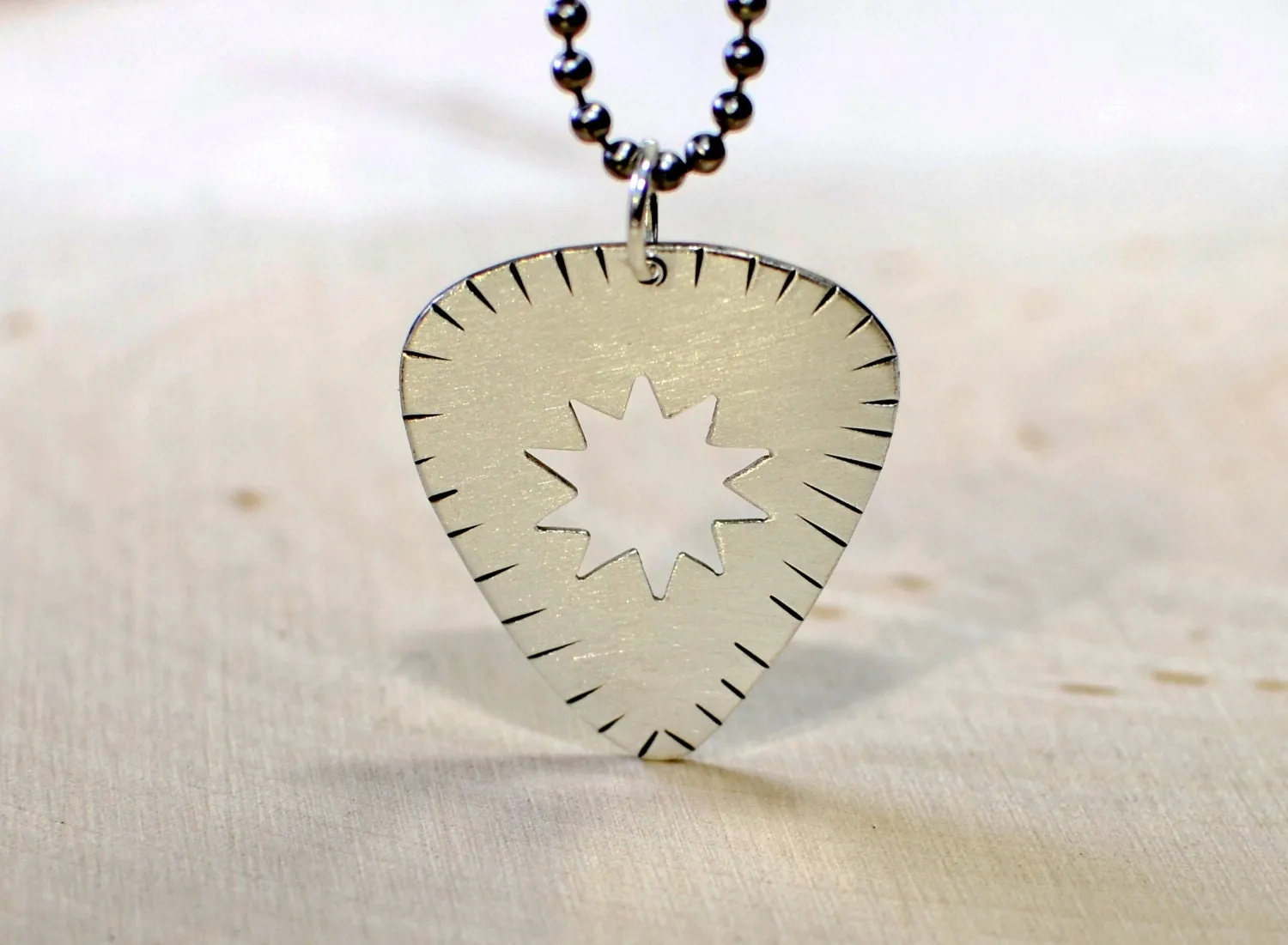 Sunburst guitar pick necklace in sterling silver