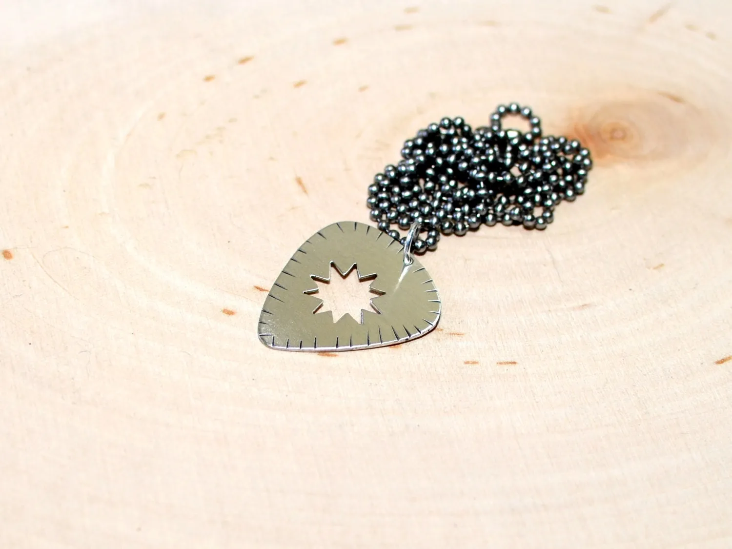 Sunburst guitar pick necklace in sterling silver