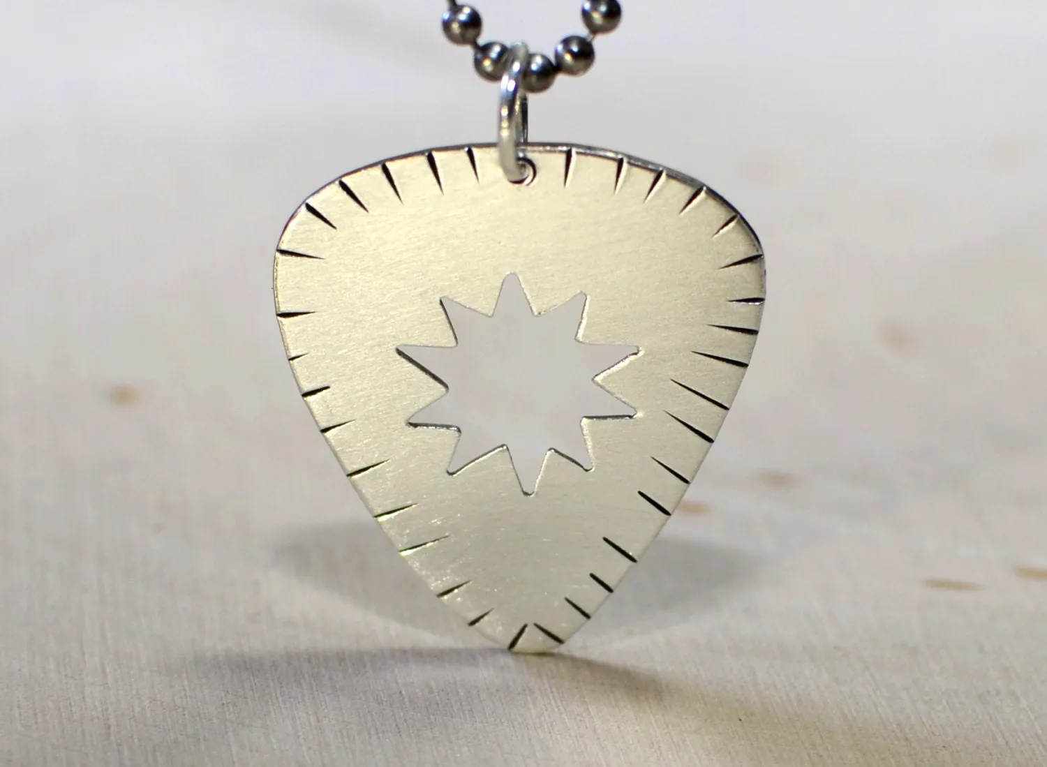 Sunburst guitar pick necklace in sterling silver