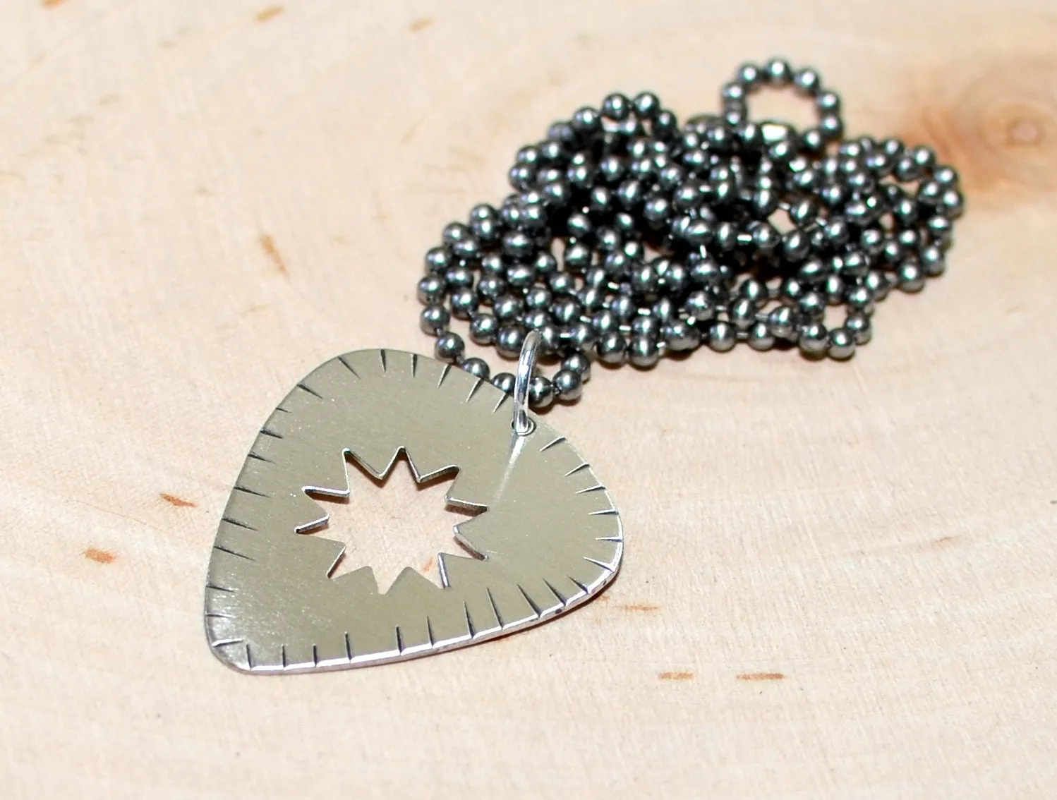 Sunburst guitar pick necklace in sterling silver