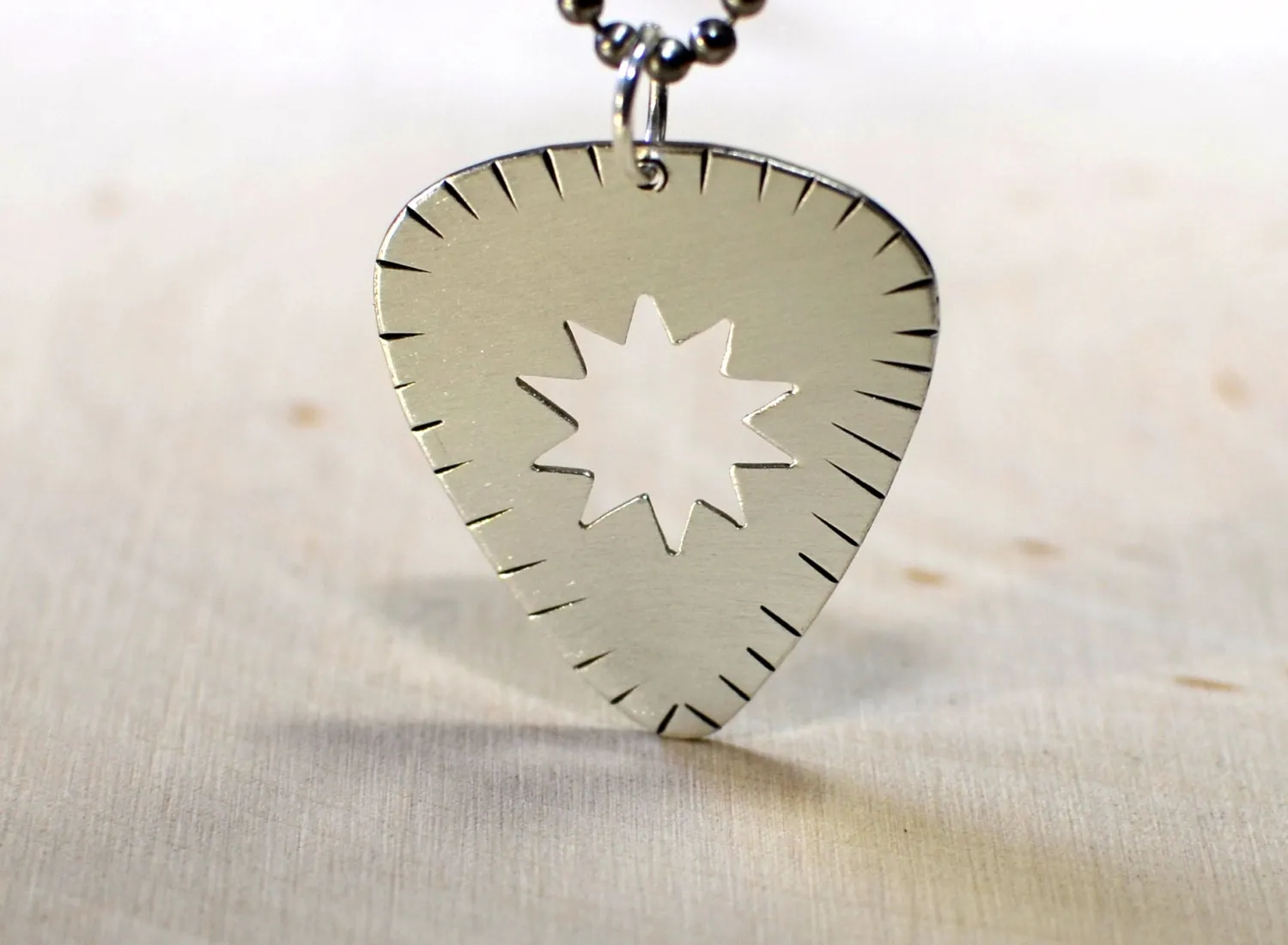 Sunburst guitar pick necklace in sterling silver